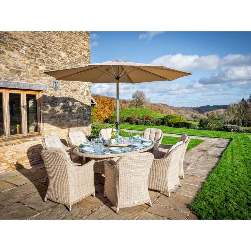Monterey Sandstone elliptical dining set with eight chairs, Lazy Susan and parasol.